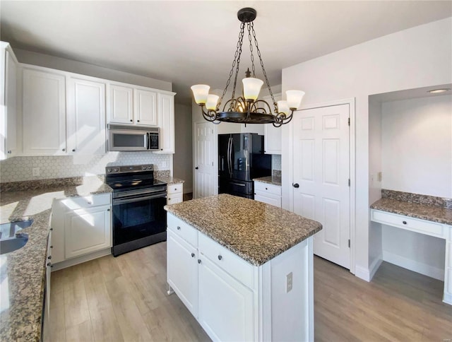 kitchen with a center island, tasteful backsplash, appliances with stainless steel finishes, light wood-style floors, and white cabinets