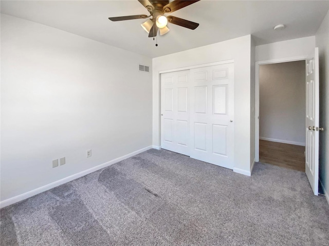 unfurnished bedroom with baseboards, a closet, visible vents, and carpet flooring