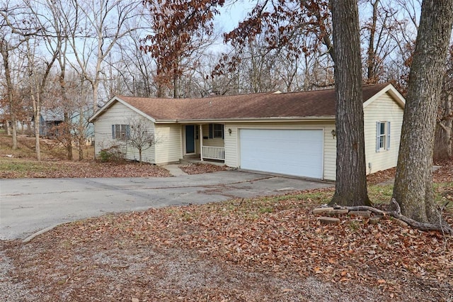 ranch-style home featuring driveway and an attached garage