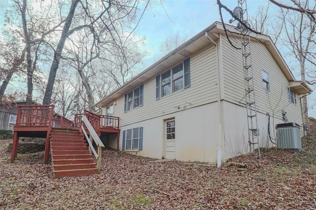 back of property featuring stairs, cooling unit, and a wooden deck