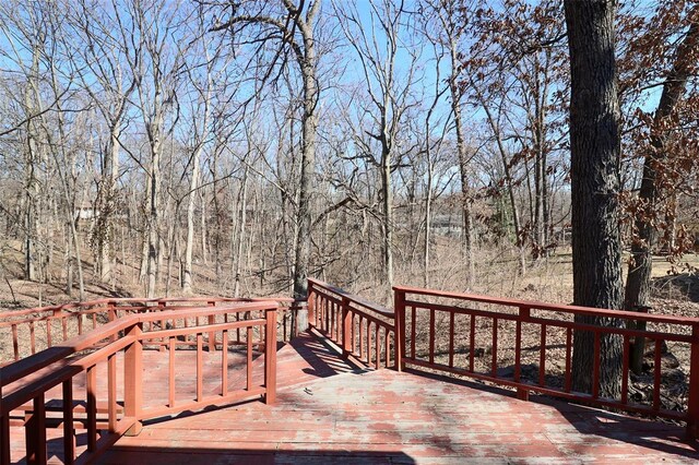 wooden deck featuring a wooded view