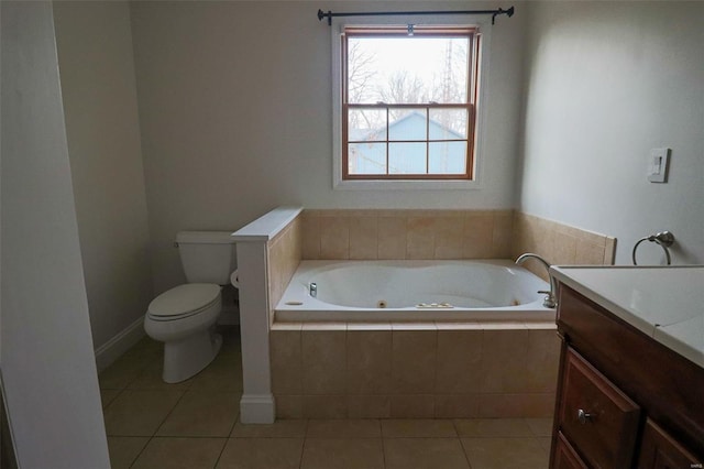 bathroom with tile patterned floors, vanity, toilet, and a whirlpool tub