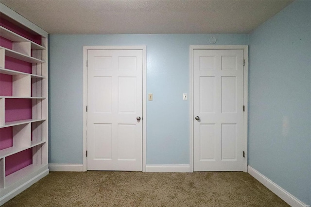 unfurnished bedroom featuring carpet flooring and baseboards