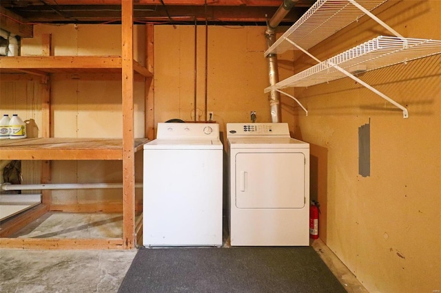 clothes washing area with washing machine and dryer