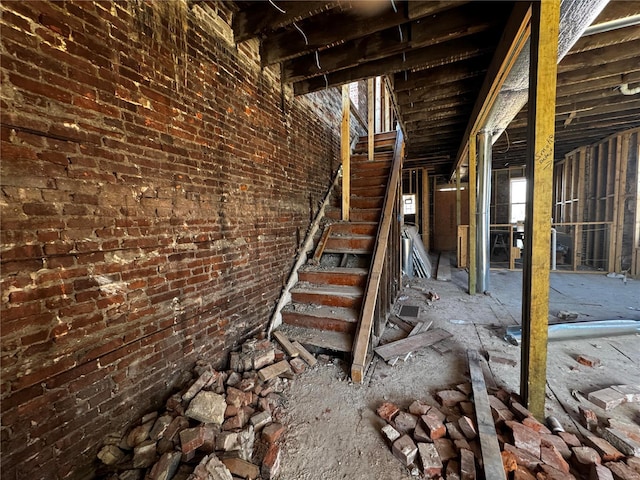 interior space featuring brick wall