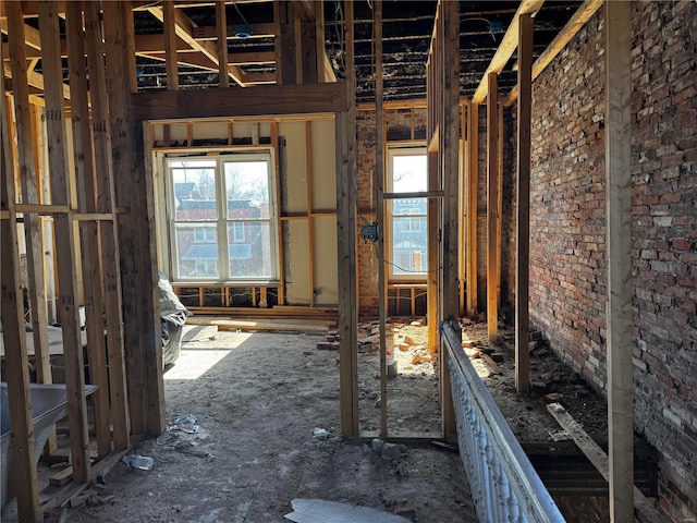miscellaneous room with a wealth of natural light and brick wall