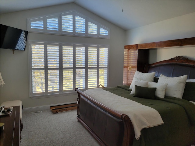 carpeted bedroom featuring lofted ceiling, visible vents, and baseboards