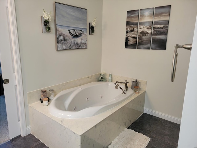 full bath featuring a tub with jets and tile patterned floors