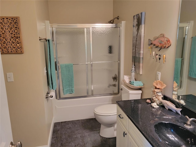 bathroom featuring toilet, bath / shower combo with glass door, and vanity