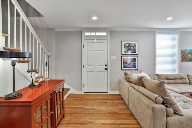 entryway with stairs, light wood finished floors, baseboards, and recessed lighting