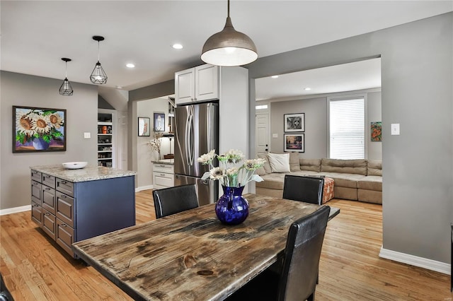 dining room featuring recessed lighting, light wood-style flooring, and baseboards