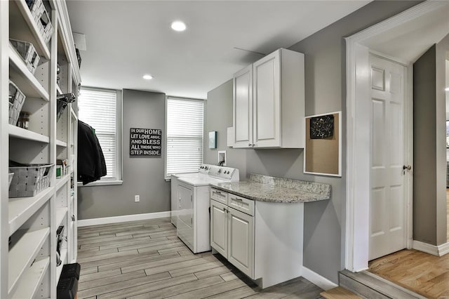 clothes washing area with recessed lighting, baseboards, light wood-type flooring, cabinet space, and washer and clothes dryer