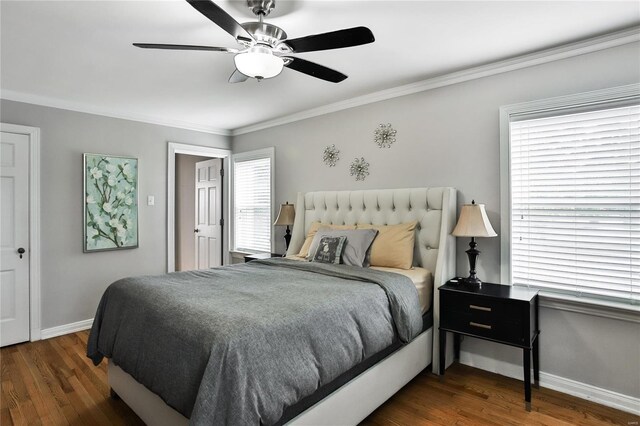 bedroom with a ceiling fan, crown molding, baseboards, and wood finished floors