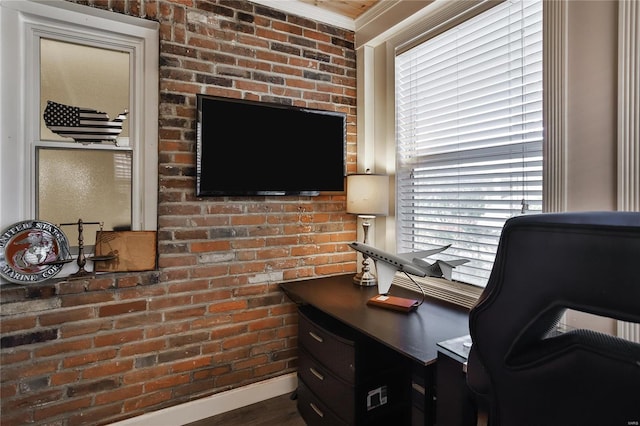 office area with ornamental molding and brick wall