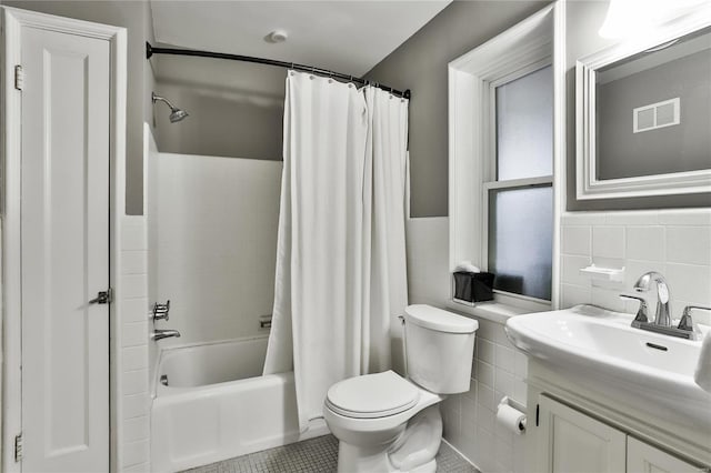 full bathroom featuring visible vents, toilet, shower / bath combination with curtain, and tile walls