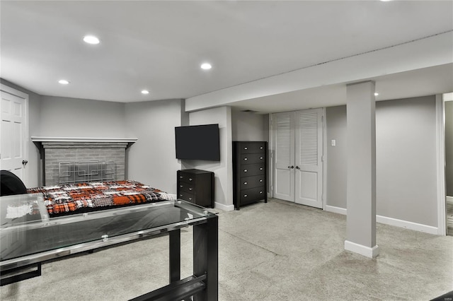 bedroom with a brick fireplace, baseboards, carpet flooring, and recessed lighting