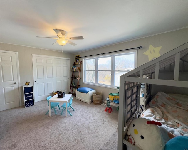 bedroom featuring carpet floors, crown molding, a closet, and a ceiling fan