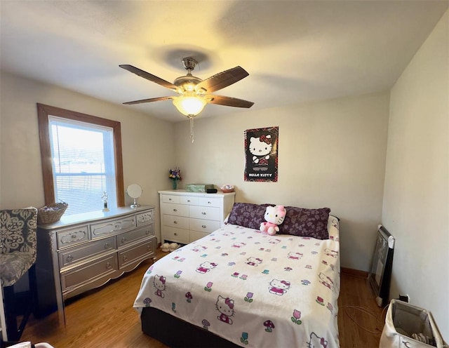 bedroom featuring wood finished floors and a ceiling fan