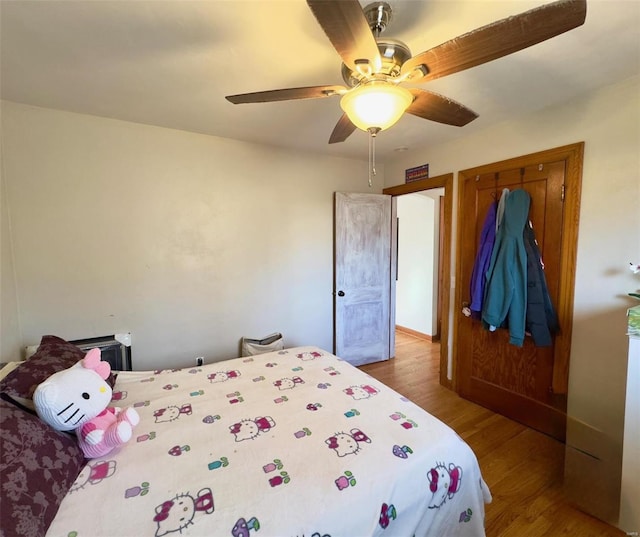 bedroom with a ceiling fan and wood finished floors