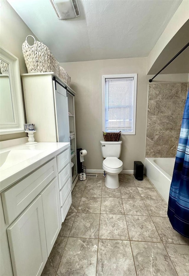 bathroom with visible vents, toilet, vanity, a textured ceiling, and baseboards