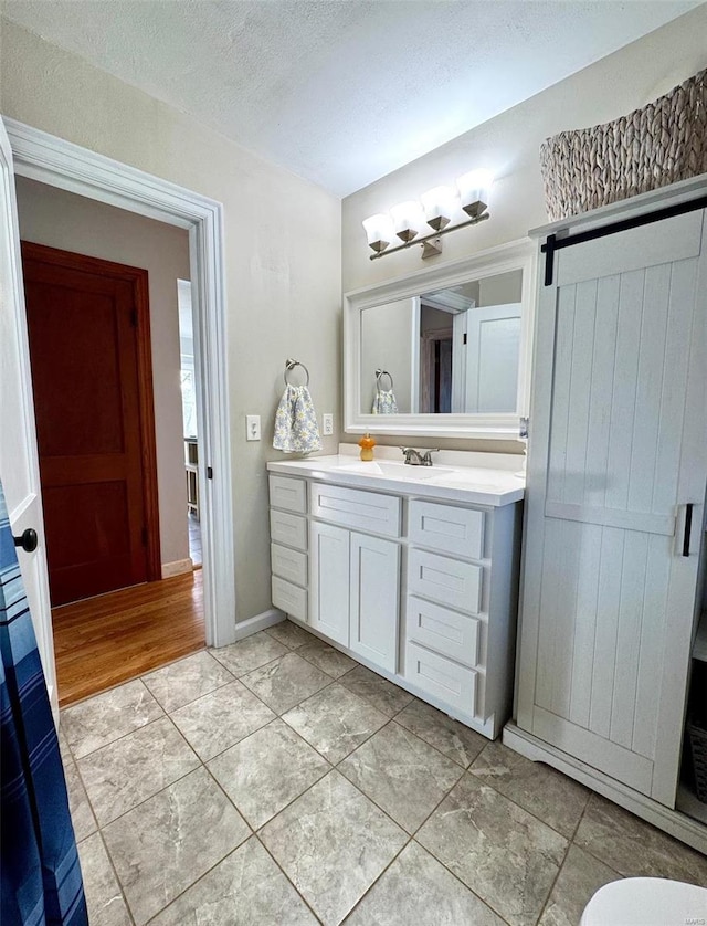 bathroom featuring a textured ceiling and vanity