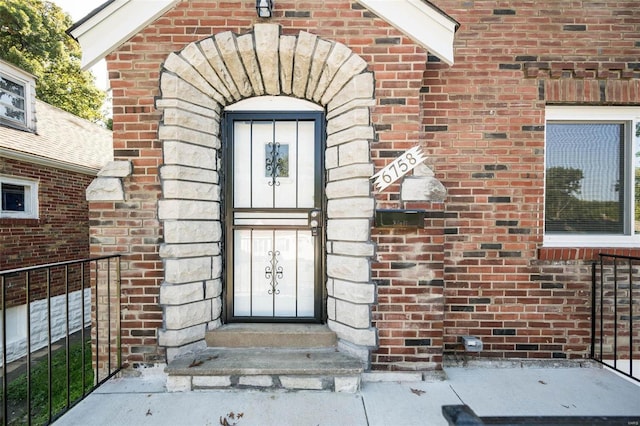 property entrance featuring brick siding