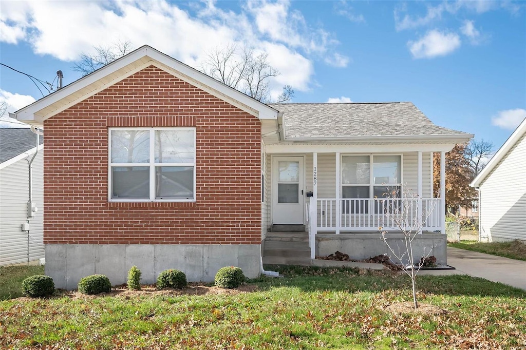 view of front of property featuring a porch and brick siding