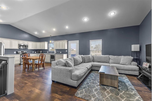 living area featuring lofted ceiling, dark wood finished floors, and recessed lighting