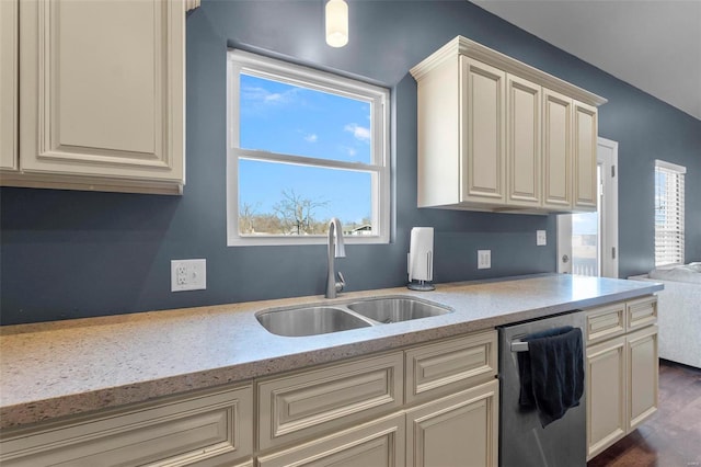 kitchen with stainless steel dishwasher, a sink, and light stone counters