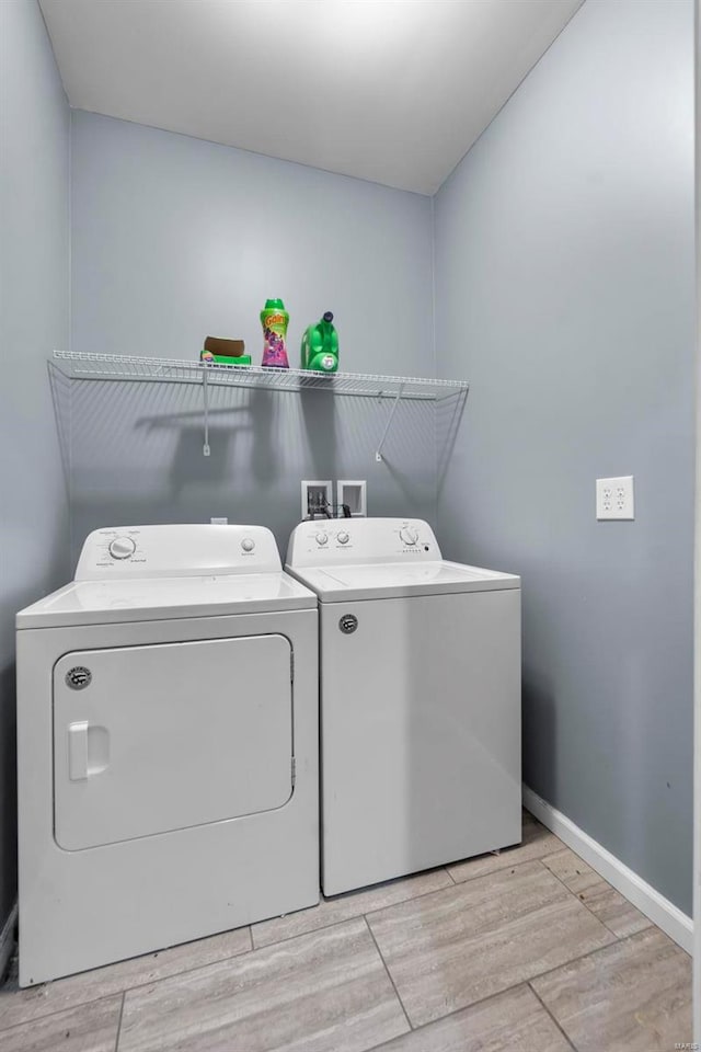 clothes washing area featuring laundry area, baseboards, light wood finished floors, and independent washer and dryer