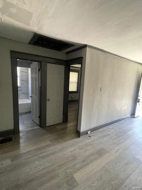 empty room featuring plenty of natural light, baseboards, and wood finished floors