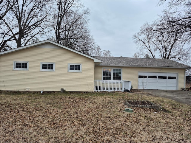 view of front facade with aphalt driveway, an attached garage, and a shingled roof