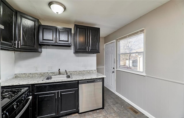 kitchen featuring light countertops, visible vents, stainless steel dishwasher, black gas stove, and dark cabinets