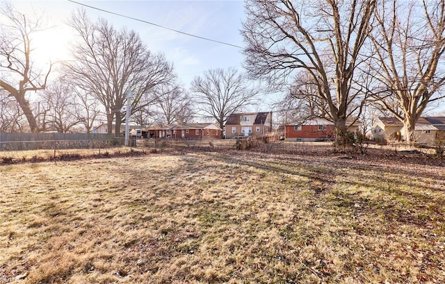 view of yard featuring fence and a residential view