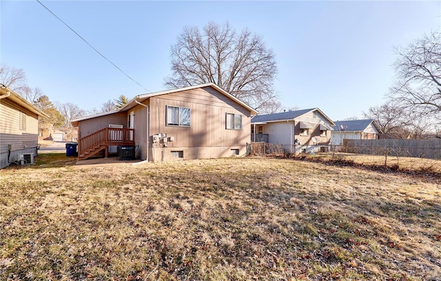 back of house featuring fence and central AC unit