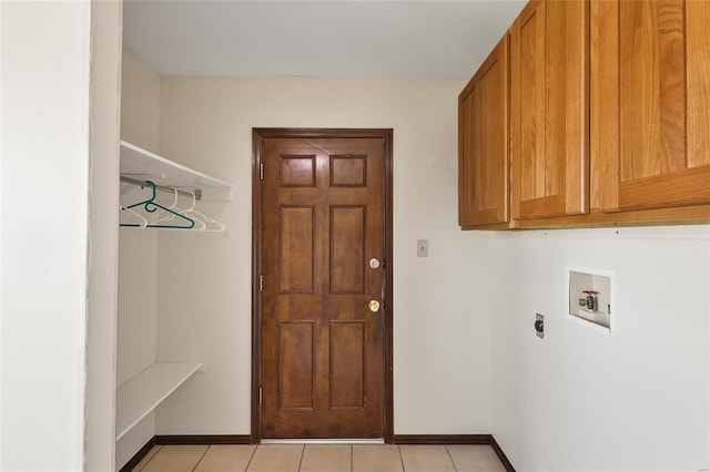 laundry area with washer hookup, light tile patterned floors, cabinet space, electric dryer hookup, and baseboards