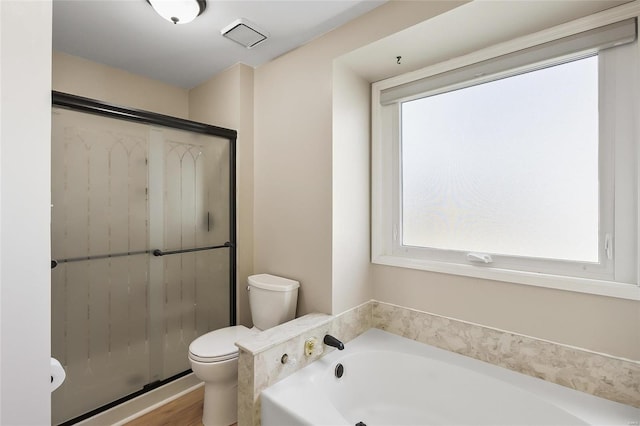 bathroom featuring toilet, a stall shower, and a bath