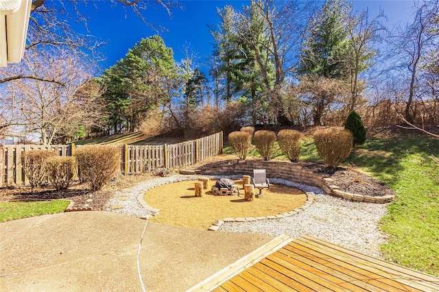 view of yard with a fire pit, a patio, and fence