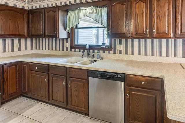 kitchen featuring light tile patterned floors, a sink, light countertops, dishwasher, and wallpapered walls