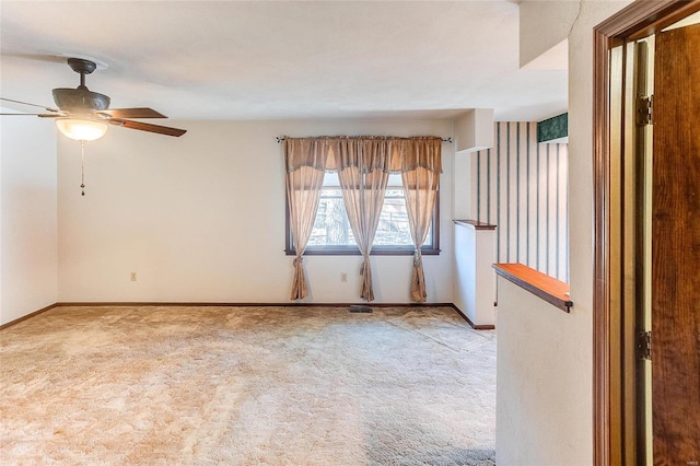 unfurnished room with carpet, ceiling fan, and baseboards