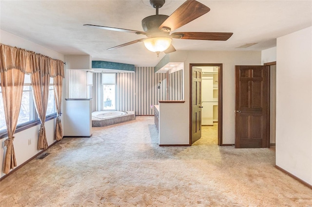 unfurnished room featuring ceiling fan, carpet, visible vents, and baseboards