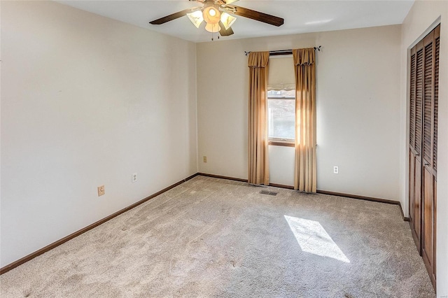 unfurnished bedroom featuring light carpet, a closet, visible vents, and baseboards