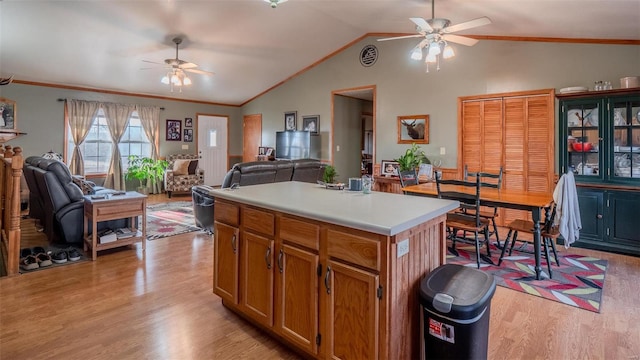 kitchen featuring vaulted ceiling, light wood-style flooring, a ceiling fan, and open floor plan