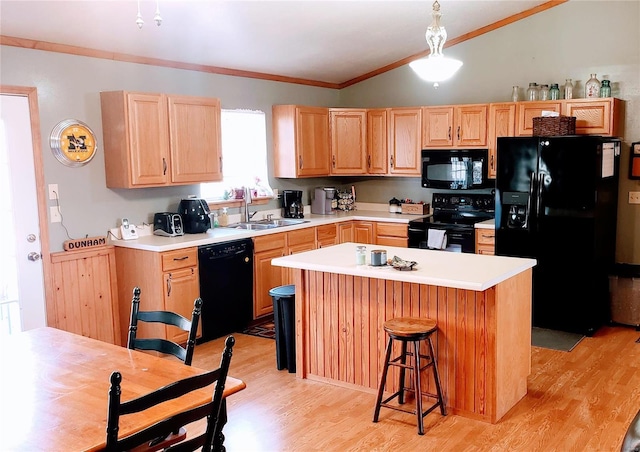 kitchen featuring light wood-style flooring, ornamental molding, a sink, black appliances, and vaulted ceiling