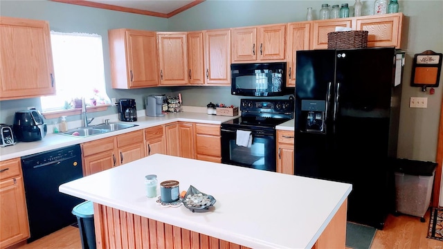 kitchen featuring a sink, black appliances, light brown cabinetry, and light countertops