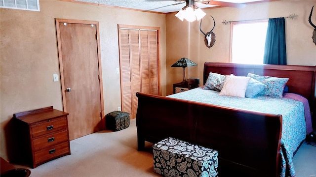 bedroom with visible vents, a ceiling fan, and carpet