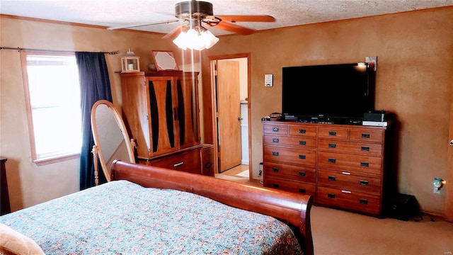 bedroom featuring carpet flooring, a textured ceiling, and ceiling fan