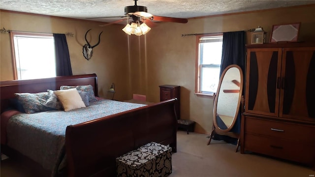 bedroom with light carpet, a textured ceiling, and a ceiling fan