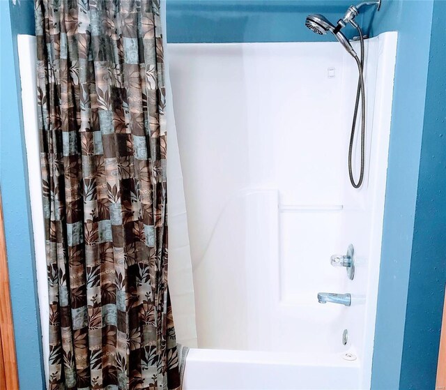 full bath featuring shower / tub combo with curtain