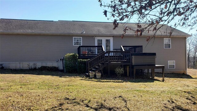 rear view of house featuring a yard, a shingled roof, a deck, and stairway